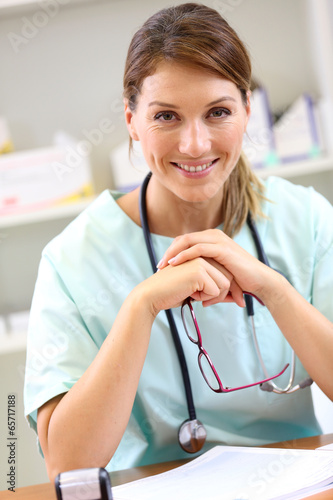 Photo: Portrait of smiling nurse in office Portrait of smiling nurse in office