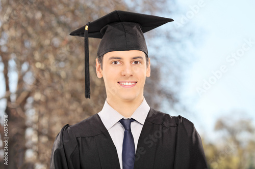 Photo: Male college graduate posing outdoors Male college graduate posing outdoors