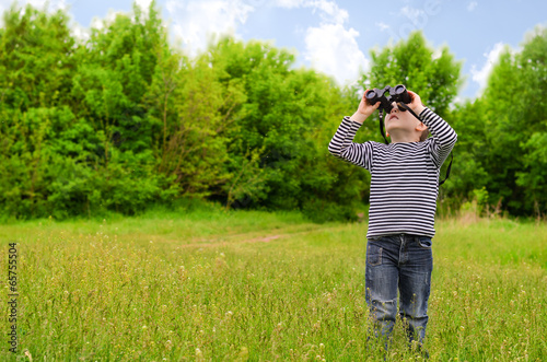 Photo: Little boy scanning the woods with binoculars Little boy scanning the woods with binoculars