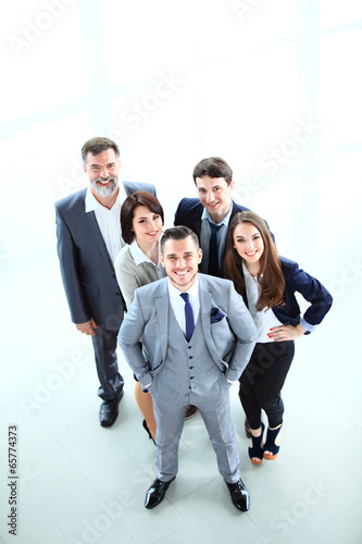 Photo: Top view of business people. Happy smiling business team Top view of business people. Happy smiling business team