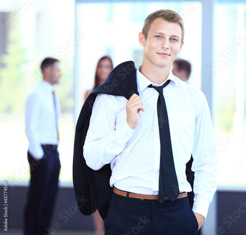Photo: Businessman with colleagues in the background Businessman with colleagues in the background