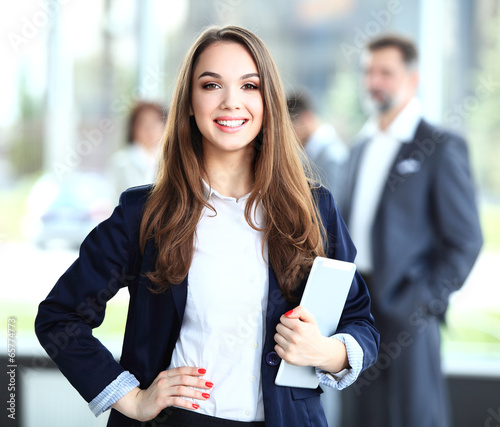 Photo: Business woman standing with a tablet in her hands Business woman standing with a tablet in her hands