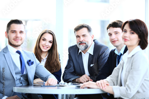 Photo: business concept - business team having meeting in office business concept - business team having meeting in office