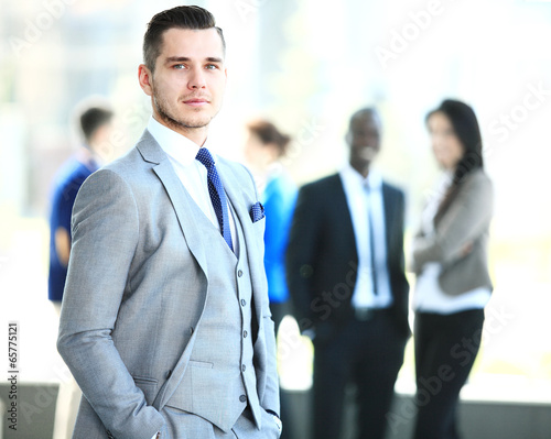 Photo: Happy smart business man with team mates discussing Happy smart business man with team mates discussing