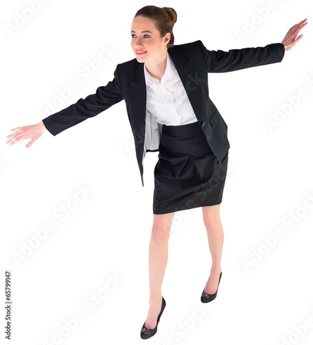 Photo: Businesswoman performing a balancing act Businesswoman performing a balancing act