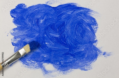 Photo: Blue paint with paintbrush Blue paint with paintbrush