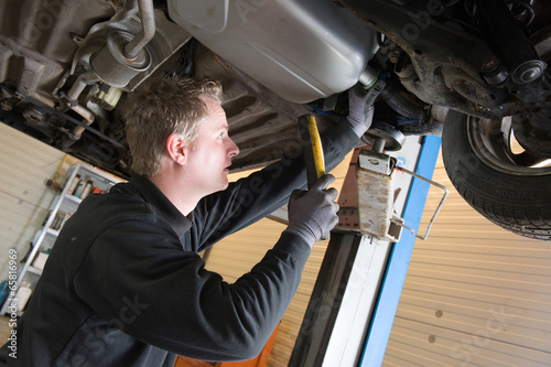 Photo: Repairing and checking a car Repairing and checking a car