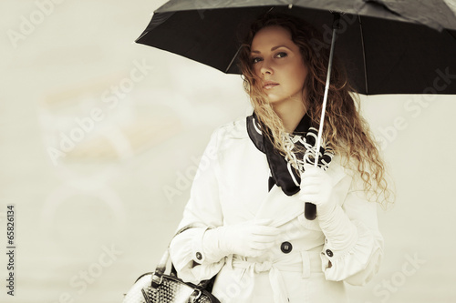 Photo: Fashion woman with umbrella in the rain Fashion woman with umbrella in the rain