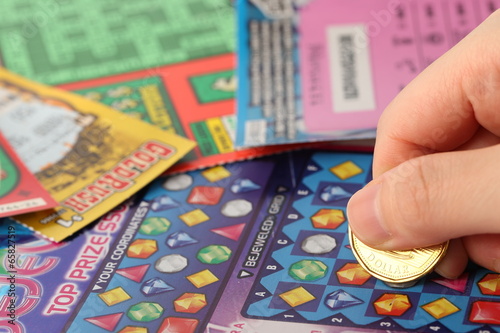 Photo: Scratching lottery tickets Scratching lottery tickets