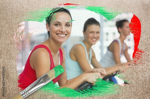 Photo: Composite image of spinning class in the gym Composite image of spinning class in the gym