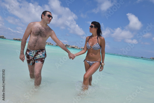 Photo: happy young couple have fun on beach happy young couple have fun on beach