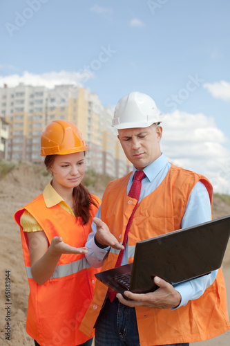 Photo: two workers on the building site two workers on the building site