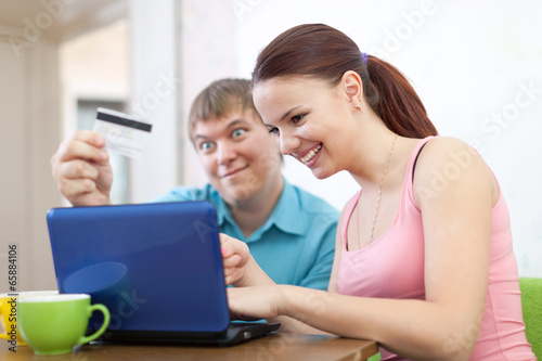 Photo: couple shopping online at home couple shopping online at home