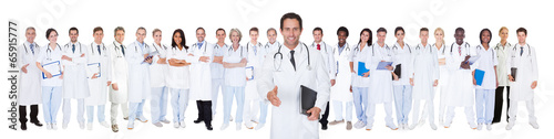 Photo: Confident Doctors Against White Background Confident Doctors Against White Background