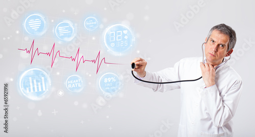 Photo: Doctor examinating modern heartbeat graphics Doctor examinating modern heartbeat graphics