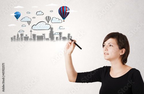 Photo: Pretty woman sketching cityscape with colorful balloons Pretty woman sketching cityscape with colorful balloons