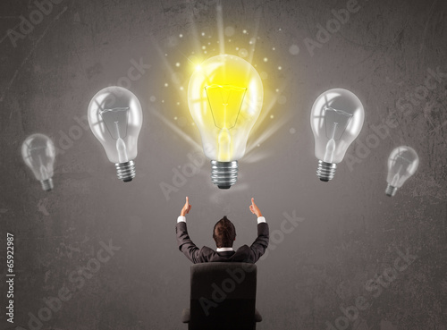 Photo: Business person having an idea light bulb concept Business person having an idea light bulb concept