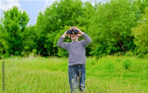 Photo: Young kid playing with binoculars Young kid playing with binoculars
