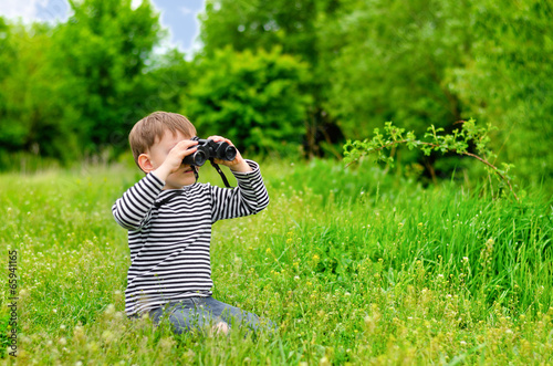 Photo: Young kid playing with binoculars Young kid playing with binoculars