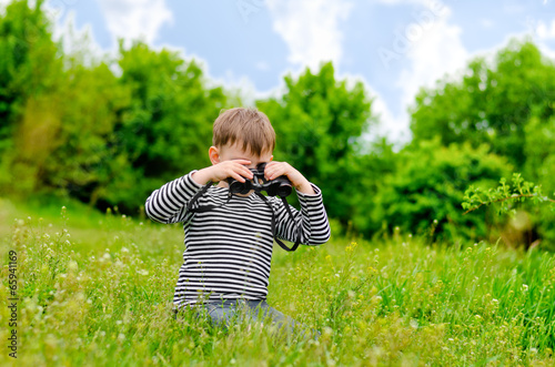 Photo: Little boy scanning the woods with binoculars Little boy scanning the woods with binoculars