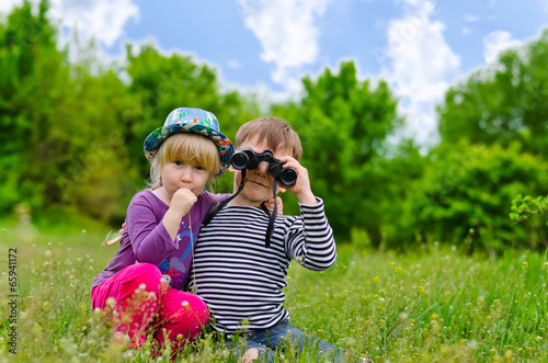 Photo: Two young children playing with binoculars Two young children playing with binoculars
