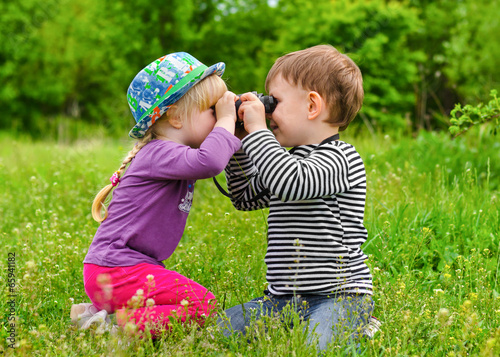 Photo: Young boy and girl playing with binoculars Young boy and girl playing with binoculars