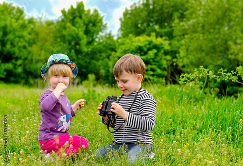 Photo: Little girl and boy playing with binoculars Little girl and boy playing with binoculars