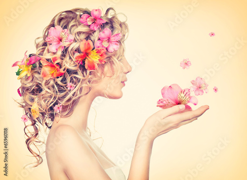 Photo: Beauty girl takes beautiful flowers in her hands Beauty girl takes beautiful flowers in her hands