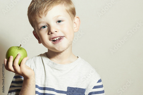 Photo: Smiling Child with apple.Little Boy.Health food.Fruits Smiling Child with apple.Little Boy.Health food.Fruits