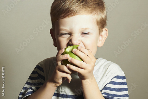 Photo: Funny Child eating apple.Little Boy.Health food.Enjoy Meal Funny Child eating apple.Little Boy.Health food.Enjoy Meal