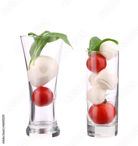 Photo: Tomatoes and mozzarella balls in glass. Tomatoes and mozzarella balls in glass.