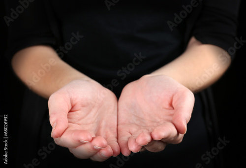 Photo: Human hands on black background Human hands on black background