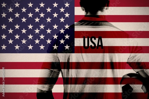 Photo: Composite image of usa football player holding ball Composite image of usa football player holding ball