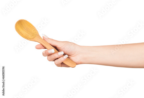 Photo: Woman hand with wooden spoon isolated on white background Woman hand with wooden spoon isolated on white background