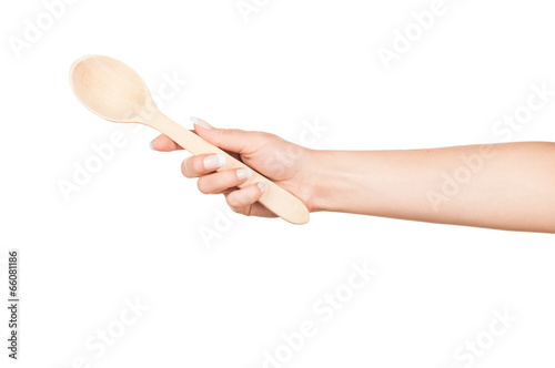 Photo: Woman hand with wooden spoon isolated on white background Woman hand with wooden spoon isolated on white background