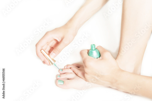 Photo: young girl paints her toenails young girl paints her toenails