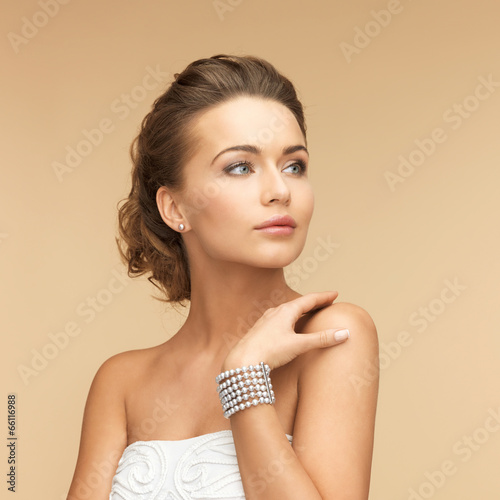Photo: woman with pearl earrings and bracelet woman with pearl earrings and bracelet
