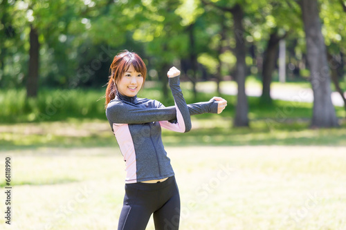 Photo: young asian woman exercising in the park young asian woman exercising in the park