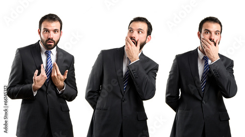 Photo: Young businessman surprised over white background Young businessman surprised over white background