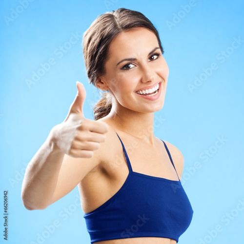 Photo: Woman in fitness wear, over blue Woman in fitness wear, over blue