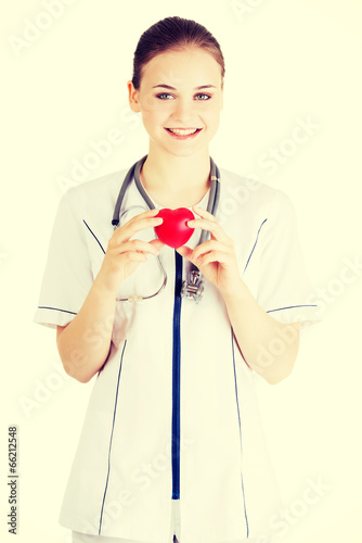 Photo: Young nurse with heart in her hand Young nurse with heart in her hand