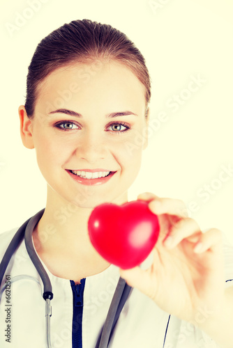 Photo: Young nurse with heart in her hand Young nurse with heart in her hand