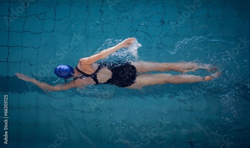 Photo: Fit woman swimming in the pool Fit woman swimming in the pool