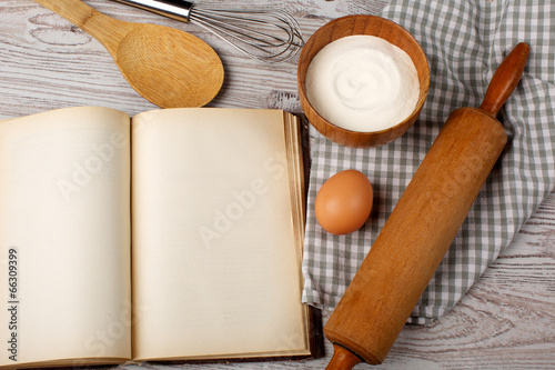 Photo: Cooking concept. Ingredients and kitchen tools with the old blan Cooking concept. Ingredients and kitchen tools with the old blan