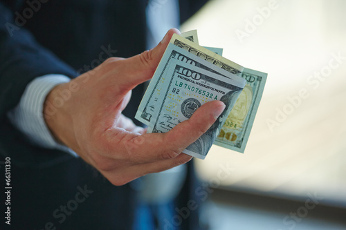 Photo: Businessman holding money in his hands Businessman holding money in his hands