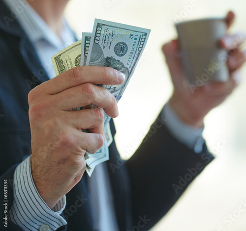 Photo: Businessman holding money in his hands Businessman holding money in his hands