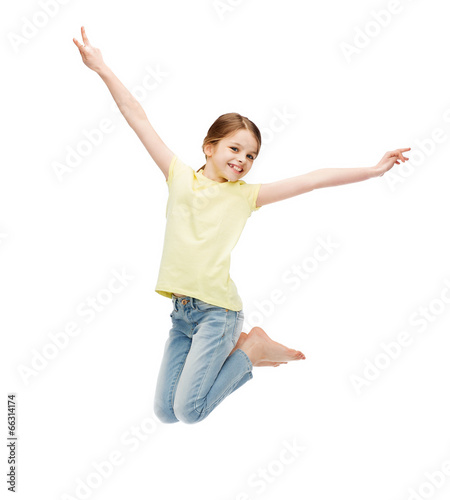 Photo: smiling little girl jumping smiling little girl jumping