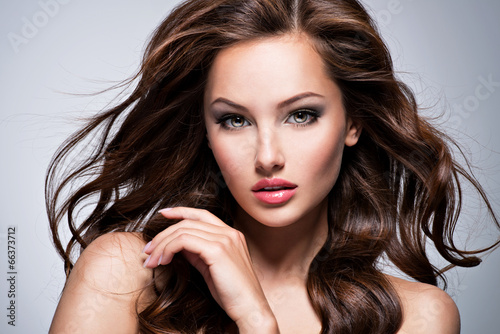 Photo: Beautiful woman with long curly hair Beautiful woman with long curly hair