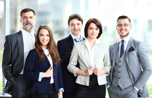 Photo: Happy smiling business team in office Happy smiling business team in office