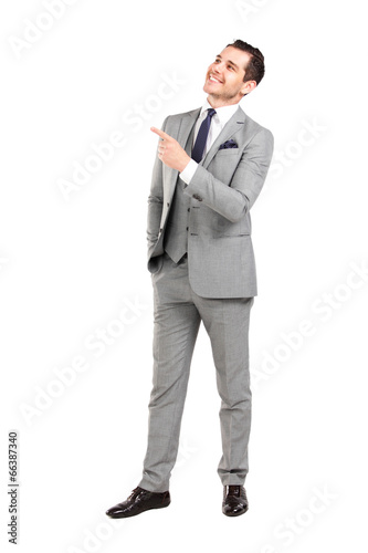 Photo: Young surprised business man pointing at something interesting Young surprised business man pointing at something interesting